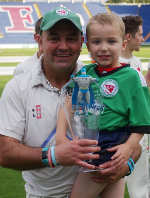 Winning Ammanford captain Alun Evans with his son and glassware trophy